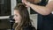 Professional hairdresser stylist curling up teen girl hair