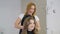 Professional hairdresser stylist curling up teen girl hair