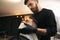 Professional hairdresser using cold towel to calm client`s skin after shaving