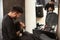 Professional hairdresser using cold towel to calm client`s skin after shaving