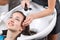 Professional hairdresser washing head