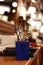 Professional hairdressing tools. Various steel scissors and combs, hairbrushes on wooden table on barbers workplace at