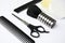 Professional hairstyling tools on background, closeup