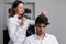 Professional hairstylist is brushing the client\'s hair with brush