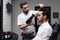 Professional hairstylist is drying the client\'s hair with hairdryer