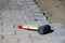 A professional hammer for fitting paving slabs to each other