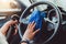 Professional hands of woman cleaning steering wheel