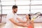 Professional handsome instructor showing woman how to play tennis