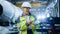 Professional Heavy Industry Female Engineer Wearing Safety Uniform, Holds Digital Tablet Computer