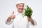 Professional hispanic mature cook chef hold salad greenery.