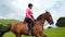 Professional horse rider riding horse slow motion. Woman in helmet horseman.