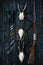 Professional hunters equipment for hunting. Rifle, knives, trophy sculps, ammunition, and others on a wooden black background. Tro