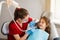 Professional hygiene for teeth of child in dentistry. Professional teeth cleaning for child girl. Pediatric dentist