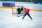 Professional ice hockey player on the ice hockey stadium train together with goalie. Sport photo, edit space, winter game Pyeongch