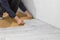 Professional installs laminate. Unrecognizable man laying laminate flooring
