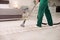 Professional janitor cleaning carpet in house