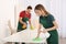 Professional janitors cleaning table in office