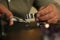 Professional jeweler working with beautiful ring at table