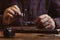 Professional jeweler working with gemstone at wooden table, closeup