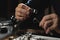 Professional jeweler working with ring at table, closeup