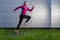 Professional Jogging Concepts. Running Mature Sportswoman Having Outdoor Jogging Training Against Abstract Metal Wall Background