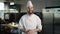 Professional kitchen portrait: Chef laughing and clapping his hands