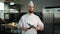 Professional kitchen portrait: Chef sharpening knives in a restaurant