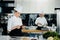 Professional kitchen of a restaurant, a female chef checks the availability of products from an employee. Restaurant warehouse