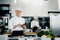 Professional kitchen of a restaurant, a male chef checks the availability of products from an employee. Restaurant warehouse