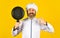 Professional kitchenware. Bearded chef preparing breakfast. Nonstick pan for frying. Enameled cooking vessels. Man hold