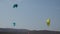 Professional Kite Surfers in action on Waves in sea.  Kites flying in air scenic background.