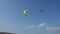 Professional Kite Surfers in action on Waves in sea.  Kites flying in air scenic background.