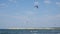 Professional Kite Surfers in action on Waves in sea. Kitesurfs make slalom on the waves.