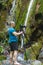 Professional landscape photographer shooting a waterfall