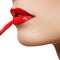 Professional lips make-up. Lipgloss and brush. Lipstick. Beauty girl applying lip gloss. lips. Beauty red lip makeup detail