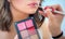 Professional lips make-up. Makeup professional artist applying lip gloss