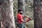 Professional lumberjack holding chainsaw in the forest. Woodcutter with axe or chainsaw in the summer forest