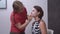 Professional makeup artist applies makeup to face of actress with special brush for shooting movie scene or theatrical