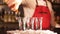 Professional male bartender pouring alcoholic drink in a shot glasses in a nightclub