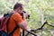 Professional male photographer in forest / Guys tourist in nature photography forest natural environment, enjoying beautiful day.