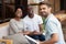 Professional male psychologist holding clipboard consulting young couple portrait