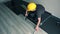 Professional male worker with yellow hard hat installing floor boards