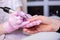 Professional manicure of male hands in a beauty salon close up. Master in gloves makes a manicure using modern