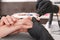 Professional manicurist working with client in salon, closeup