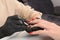 Professional manicurist working with client at table, closeup