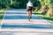 Professional marathon cyclist wearing all of his safety gear rides his bike in the green nature