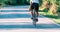 Professional marathon cyclist wearing all of his safety gear rides his bike in the green nature