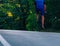 Professional marathon cyclist wearing all of his safety gear rides his bike in the green nature