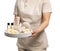 Professional masseuse in uniform holding tray with spa supplies