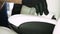 A professional master in automobile salons in black gloves imposes nano ceramics for leather using an applicator sponge, fiber t